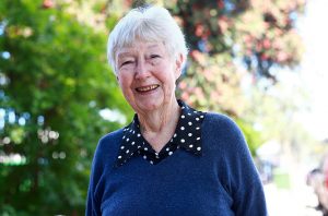 [Alt image text: Bequest donor Lee pictured outside of The Lost Dogs’ Home vet clinic which was funded by bequest gifts left by some very thoughtful animal loving supporters.]